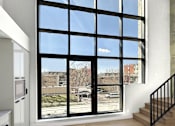 Thumbnail 4 of 5 - A kitchen with a large window overlooking a parking lot.