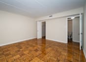 Thumbnail 3 of 33 - A room with wooden flooring and white walls.