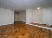 Thumbnail 4 of 33 - A room with wooden flooring and white walls.