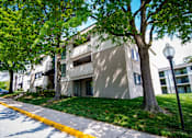 Thumbnail 27 of 33 - Ashley Apartments Tree-lined Unit Front Photo
