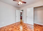 Thumbnail 3 of 24 - an empty living room with wood flooring and a ceiling fan
