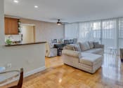 Thumbnail 8 of 50 - a living room and dining room with a couch and a table