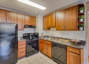 Thumbnail 4 of 50 - a kitchen with stainless steel appliances and wooden cabinets