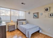 Thumbnail 12 of 50 - a bedroom with a bed and a large window