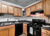 Thumbnail 1 of 40 - a kitchen with black appliances and wooden cabinets