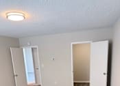 Thumbnail 9 of 40 - A bedroom with carpeted floor and three doors.
