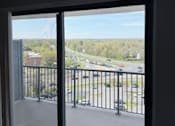 Thumbnail 1 of 40 - A view of a parking lot from a window.