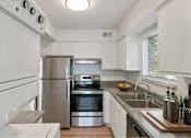 Thumbnail 98 of 111 - A modern kitchen with stainless steel appliances and white cabinets.