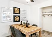 Thumbnail 106 of 111 - A dining room with a wooden table and chairs.