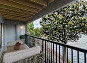 Thumbnail 110 of 111 - A balcony with a couch and a view of the water.