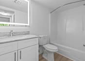 Thumbnail 13 of 111 - A white bathroom with a toilet, sink, and bathtub.