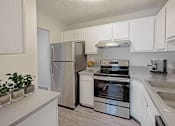 Thumbnail 16 of 111 - A kitchen with a refrigerator, oven, and sink.