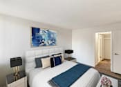 Thumbnail 20 of 111 - A bedroom with a large bed and a painting on the wall.