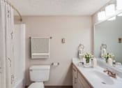Thumbnail 25 of 111 - A white toilet sits next to a white sink in a bathroom.