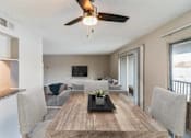 Thumbnail 29 of 111 - A modern dining room with a wooden table and chairs.