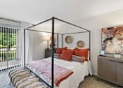 Thumbnail 39 of 111 - A bedroom with a four poster bed and a large window.