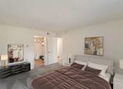 Thumbnail 46 of 111 - A bedroom with a large bed and a painting on the wall.