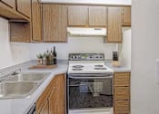 Thumbnail 50 of 111 - A modern kitchen with wooden cabinets and stainless steel appliances.