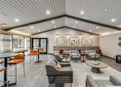 Thumbnail 57 of 111 - A spacious waiting area with a variety of seating options and artwork on the walls.