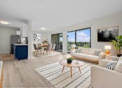 Thumbnail 5 of 111 - A modern living room with a white sofa, wooden coffee table, and a large window.