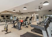 Thumbnail 62 of 111 - A gym with treadmills, elliptical machines, and other exercise equipment.