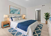 Thumbnail 6 of 111 - A bedroom with a large bed and a painting of a wave above it.