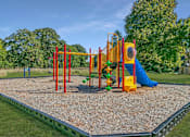 Thumbnail 83 of 111 - A playground with a yellow slide and a green slide.