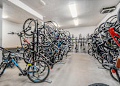 Thumbnail 15 of 26 - A bike parking room with many bikes.