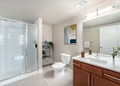 Thumbnail 9 of 26 - A bathroom with a toilet, sink, and shower.