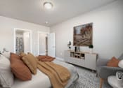 Thumbnail 10 of 26 - A bedroom with a bed, a chair, and a painting on the wall.