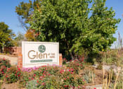 Thumbnail 24 of 29 - a sign for glen at the park in front of a tree