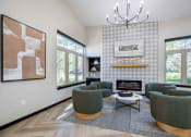 Thumbnail 16 of 29 - a living room with green chairs and a fireplace
