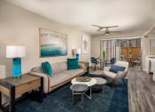 Thumbnail 2 of 28 - Oceanside CA Apartments - Stone Arbor - Spacious Living Room with Wood-Style Flooring and Attached Private Patio