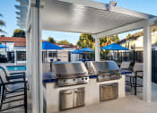 Thumbnail 18 of 28 - Stone Arbor Pool Barbecue Area