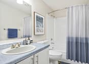 Thumbnail 4 of 24 - a bathroom with a shower and a sink and a toilet