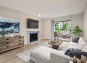 Thumbnail 1 of 24 - a living room with a couch and a tv and a fireplace