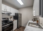 Thumbnail 3 of 19 - a kitchen with white cabinets and stainless steel appliances