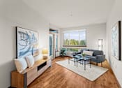 Thumbnail 23 of 27 - A modern living room with a large window and a view of trees outside.