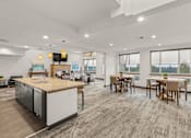 Thumbnail 17 of 27 - A modern kitchen with a dining table and chairs.