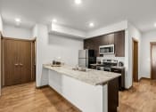Thumbnail 5 of 27 - a kitchen with a marble counter top and at Latitude 47, University Place