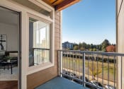 Thumbnail 11 of 27 - a balcony with a view of a yard and a glass door at Latitude 47, University Place