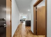 Thumbnail 4 of 27 - a door is open to a hallway with a kitchen and a living room at Latitude 47, University Place