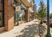 Thumbnail 3 of 27 - a city sidewalk in front of a brick building at Latitude 47, University Place