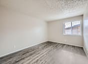 Thumbnail 23 of 28 - an empty bedroom with wood flooring and a window