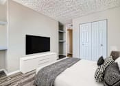 Thumbnail 7 of 28 - a bedroom with a large bed in front of a tv
