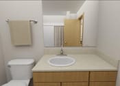 Thumbnail 11 of 36 - A white toilet sits next to a sink in a small bathroom.