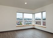 Thumbnail 16 of 36 - A room with a large window overlooking a parking lot.