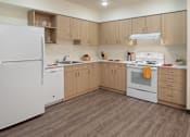 Thumbnail 18 of 36 - A kitchen with a white refrigerator and white stove.