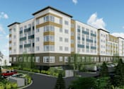 Thumbnail 34 of 36 - A modern multi-story building with a parking lot in front.