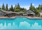 Thumbnail 2 of 10 - A large house with a pool in the backyard.